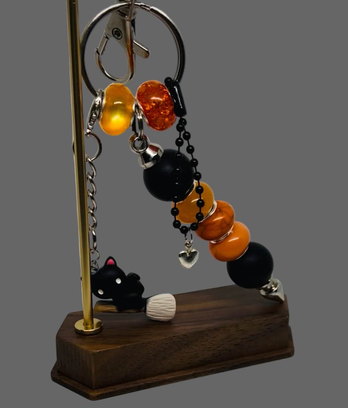 Decorative Halloween 3 in One keychain with beads and charms on a stand against a gray background