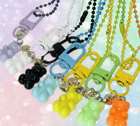Colorful gummy bear keychains on a soft gradient background. party favors. comes with earrings.