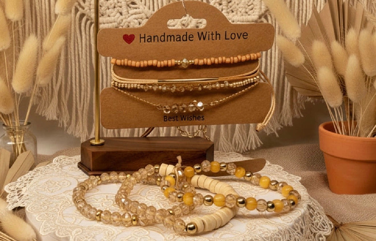 Handmade 7-piece jewelry set on a wooden stand with 'Handmade With Love' sign, surrounded by decorative elements. Champagne Glass Beads.