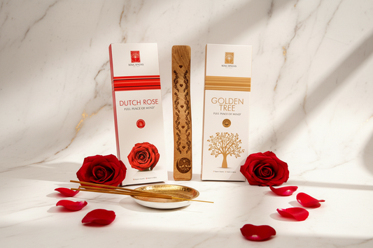 Two incense boxes labeled 'Dutch Rose' and 'Golden Tree' with red roses and rose petals on a marble surface.