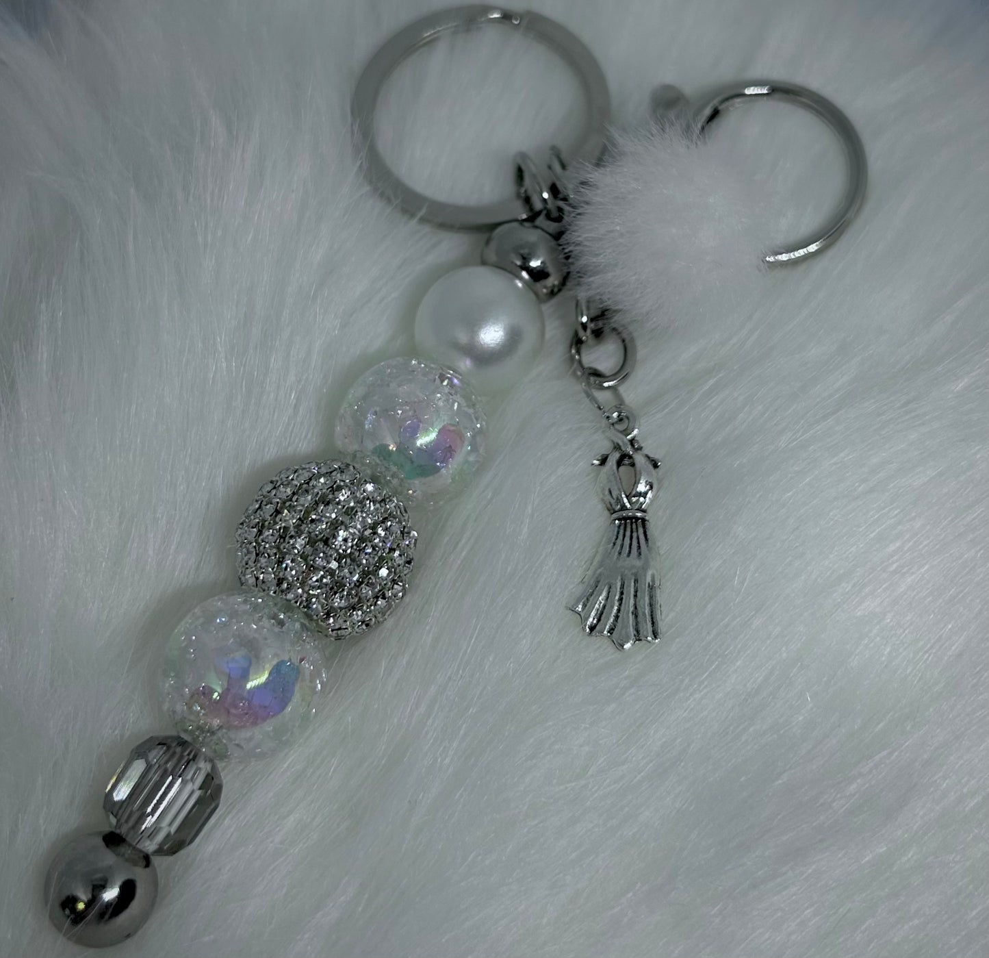 Keychain with decorative beads and charms on a textured white background. Marilyn Monroe Inspired. Monroe.