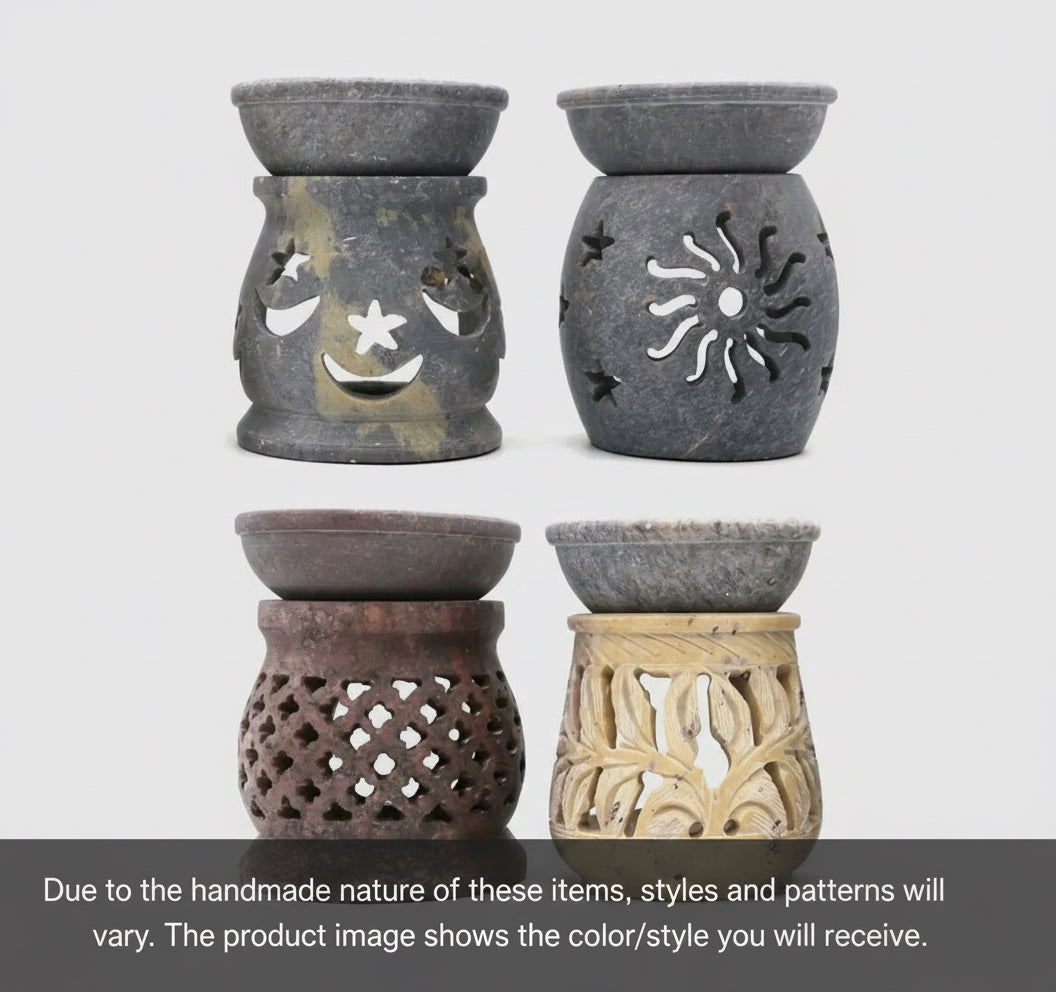 Set of four soapstone oil burners on a light gray background