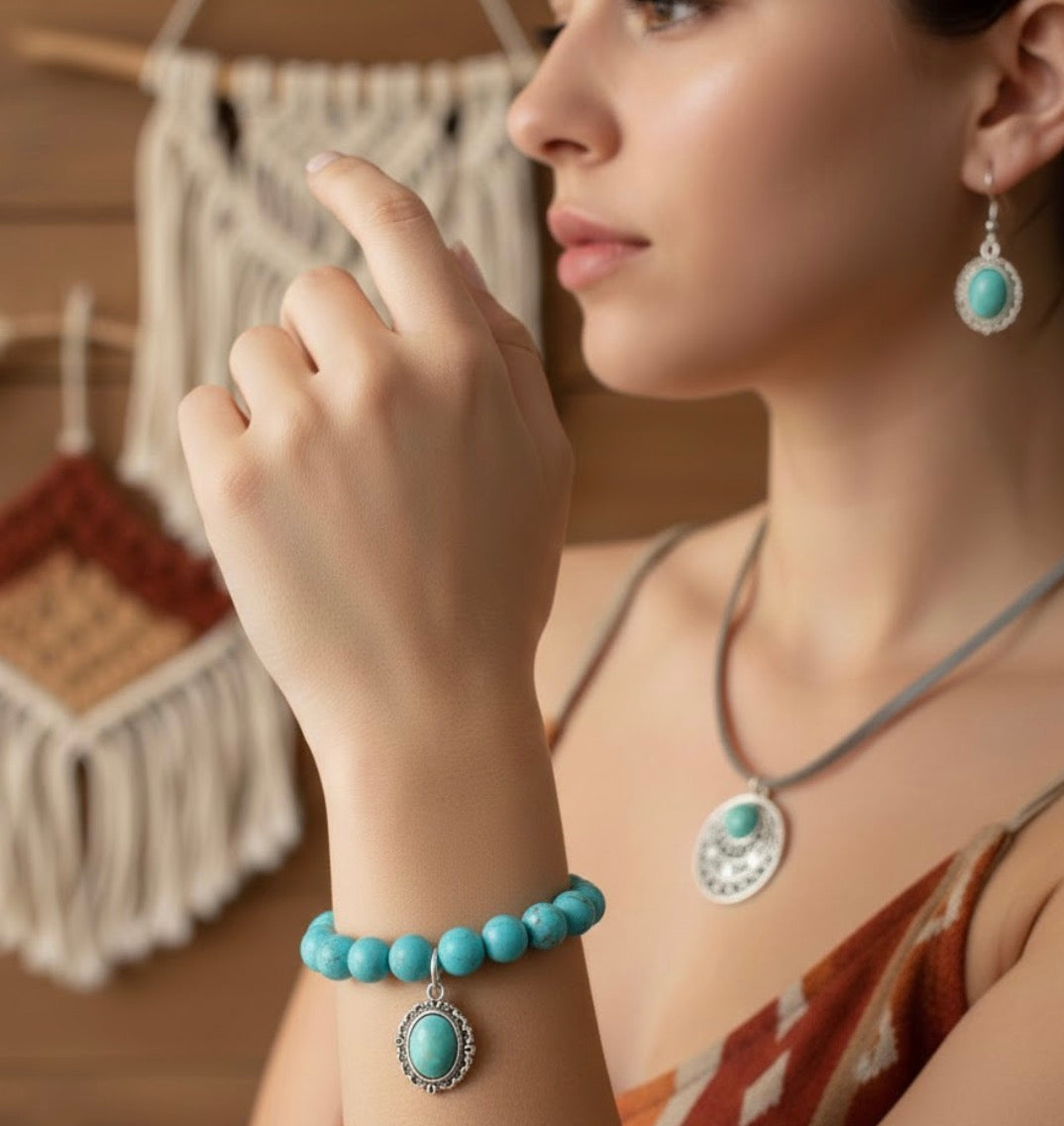 Woman wearing turquoise jewelry including a bracelet and earrings, with a blurred background.