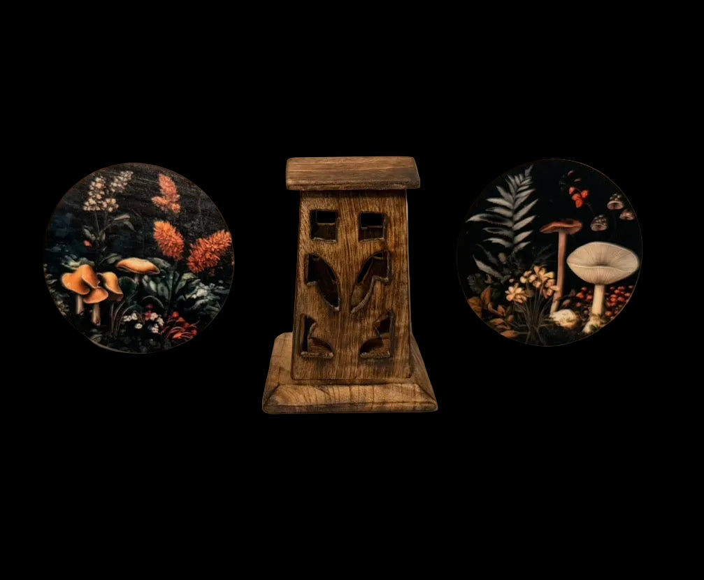 Wooden incense cone burner with two circular cottage core mushroom medallions coasters on a plain background