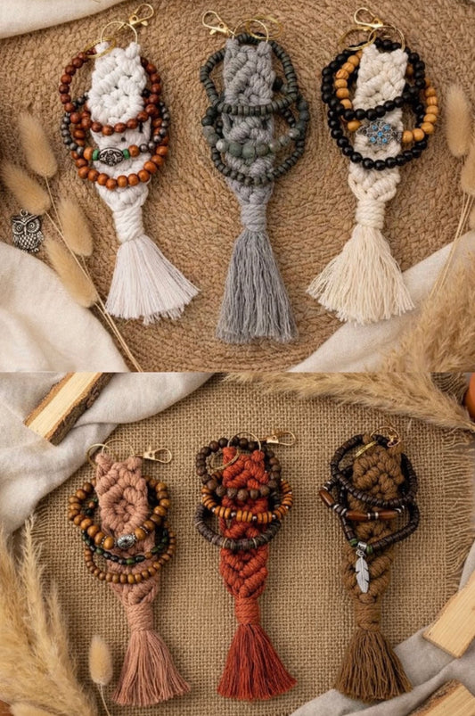 Six macrame keychains with tassels and stacked bracelets on a textured surface