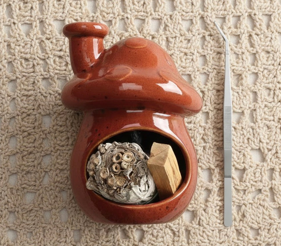 Ceramic mushroom-shaped incense burner with wooden block and spherical object on a textured beige background