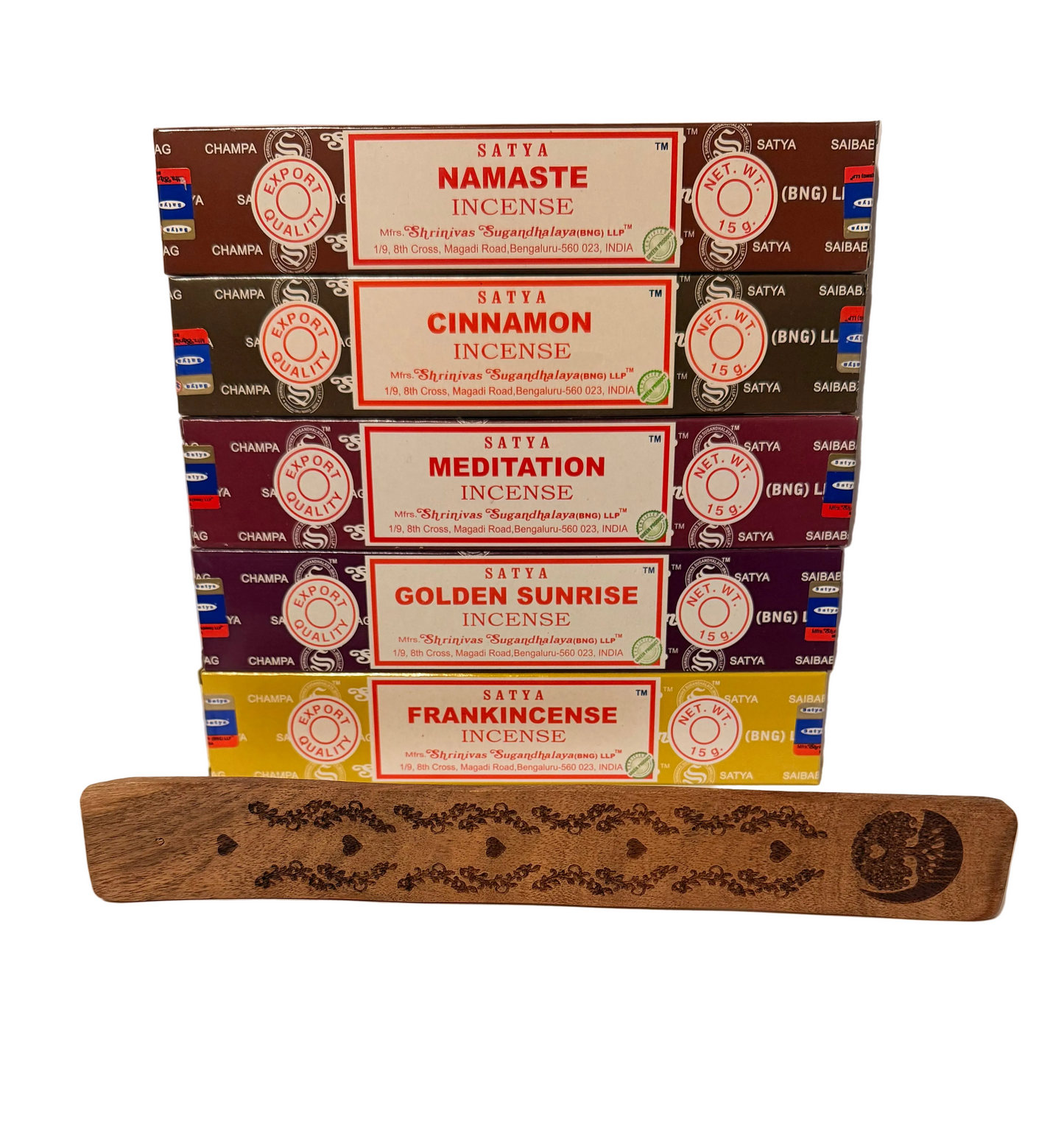Stack of Satya incense boxes with a wooden incense stick holder on a white background