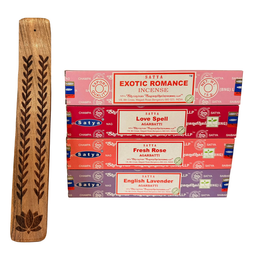 Stack of Satya incense boxes with a wooden stick on a white background