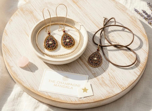 Jewelry set including mandala earrings and a necklace on a wooden tray with a card below.