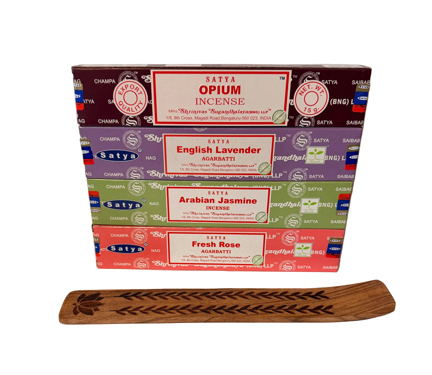Stack of Satya incense boxes with a wooden incense holder on a white background