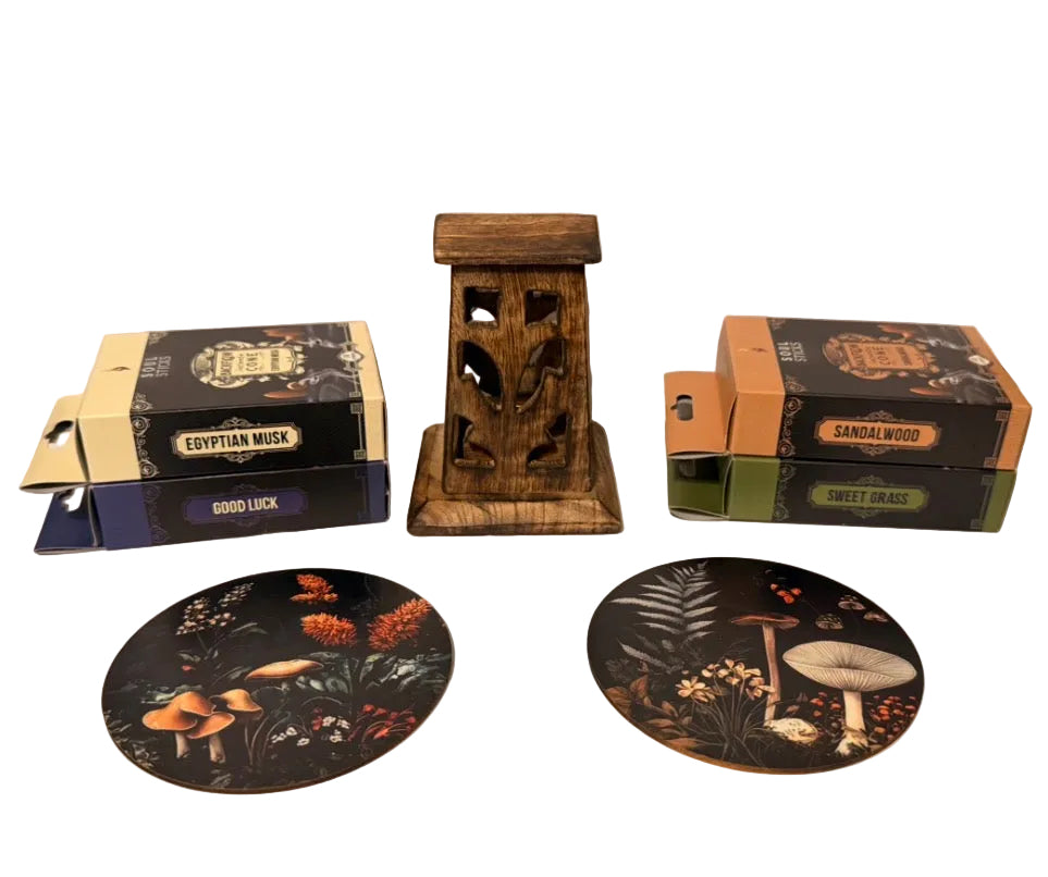 Wooden incense burner tower with incense labeled 'Egyptian Musk' and 'Sandalwood' on a white surface.