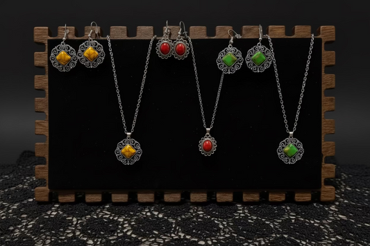 Jewelry set with pendants and earrings on a wooden stand against a dark background