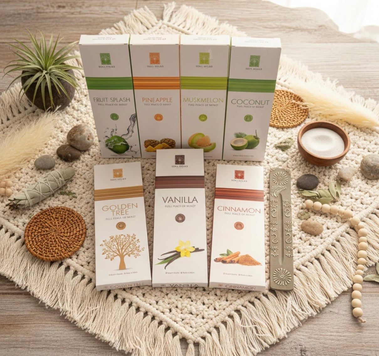 Collection of incense boxes with various flavors on a textured surface with decorative items.