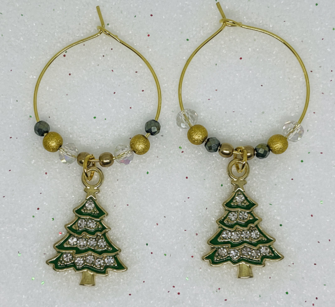 gold hoop wine glass charm with Christmas tree charms on a white background