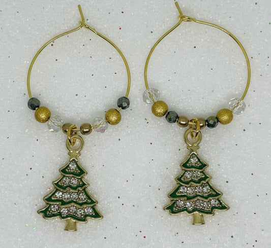 gold hoop wine glass charm with Christmas tree charms on a white background
