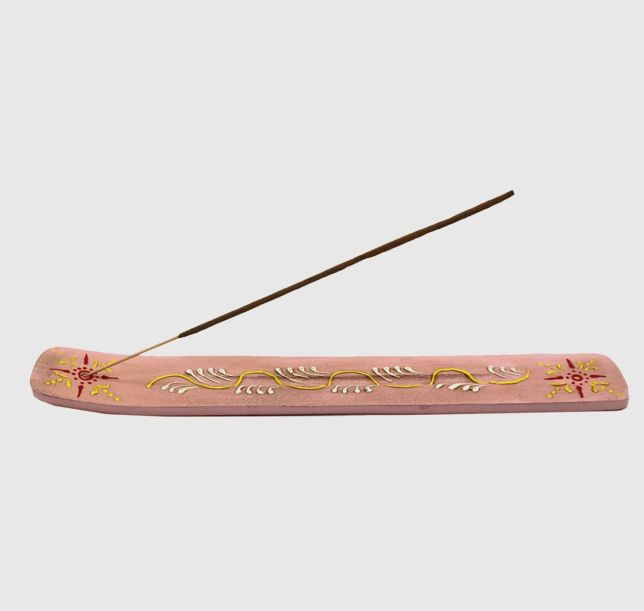 Decorative pink and yellow hand painted incense holder with floral designs on a white background