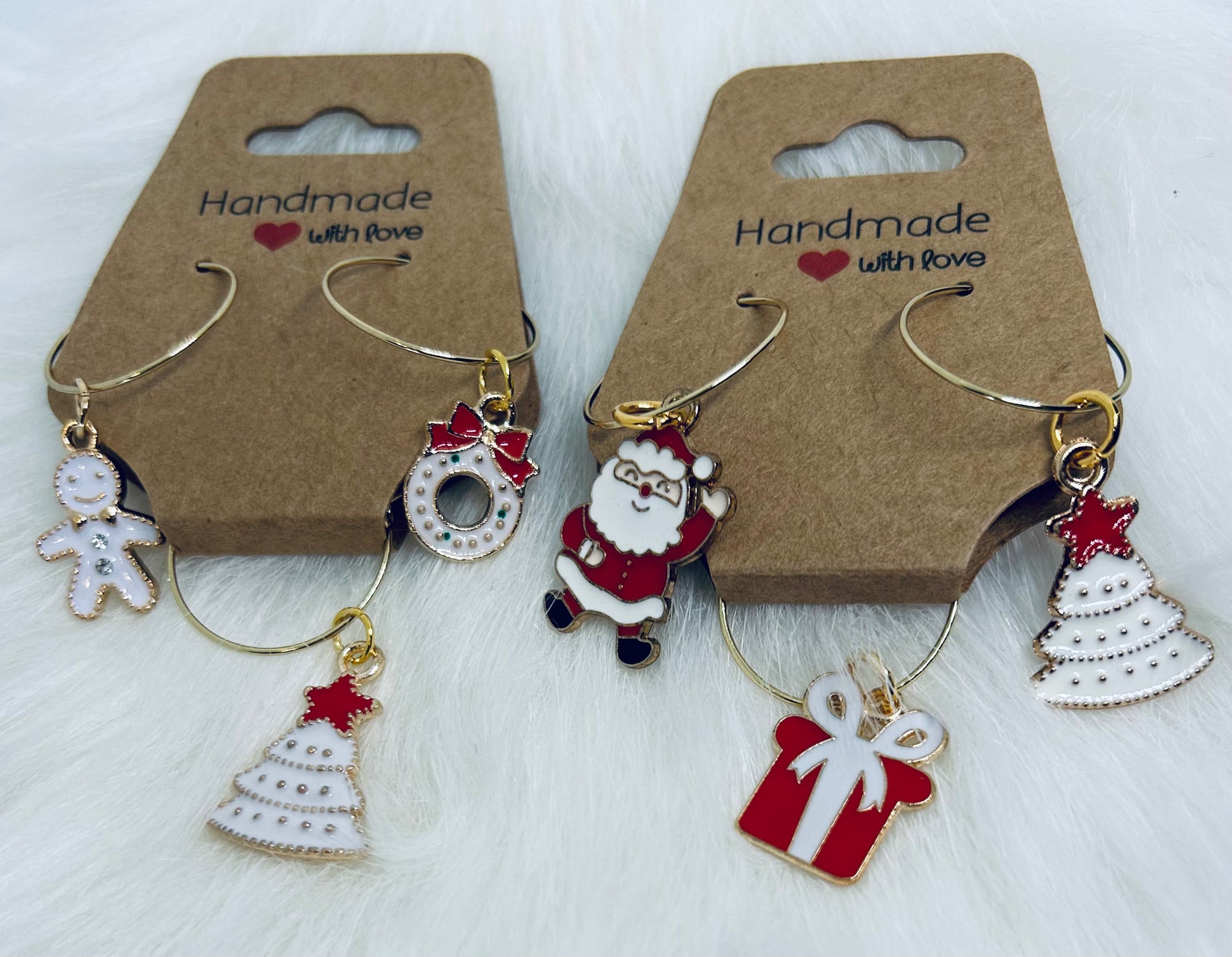 Set of Christmas-themed 18k gold plated hoop holiday wine glass charms on brown cards with 'Handmade with Love' text.