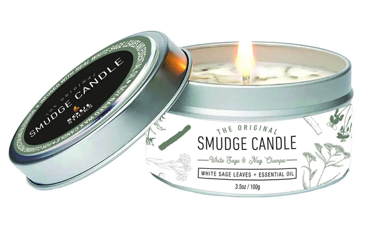 Smudge candle in a tin with a lit candle inside, on a white background