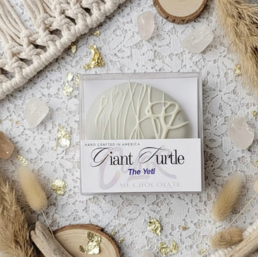 Giant Turtle chocolate packaging on a textured surface with decorative elements