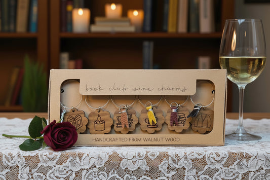 Box of book club wine charms with a glass of wine and rose on a lace tablecloth. Tea Sachets included with set. 