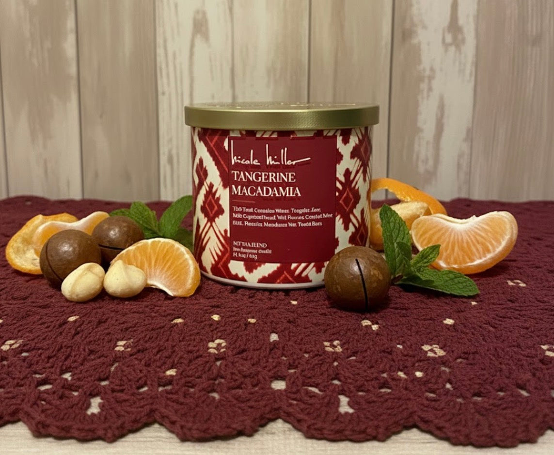 Candle with tangerine and macadamia theme on a textured surface