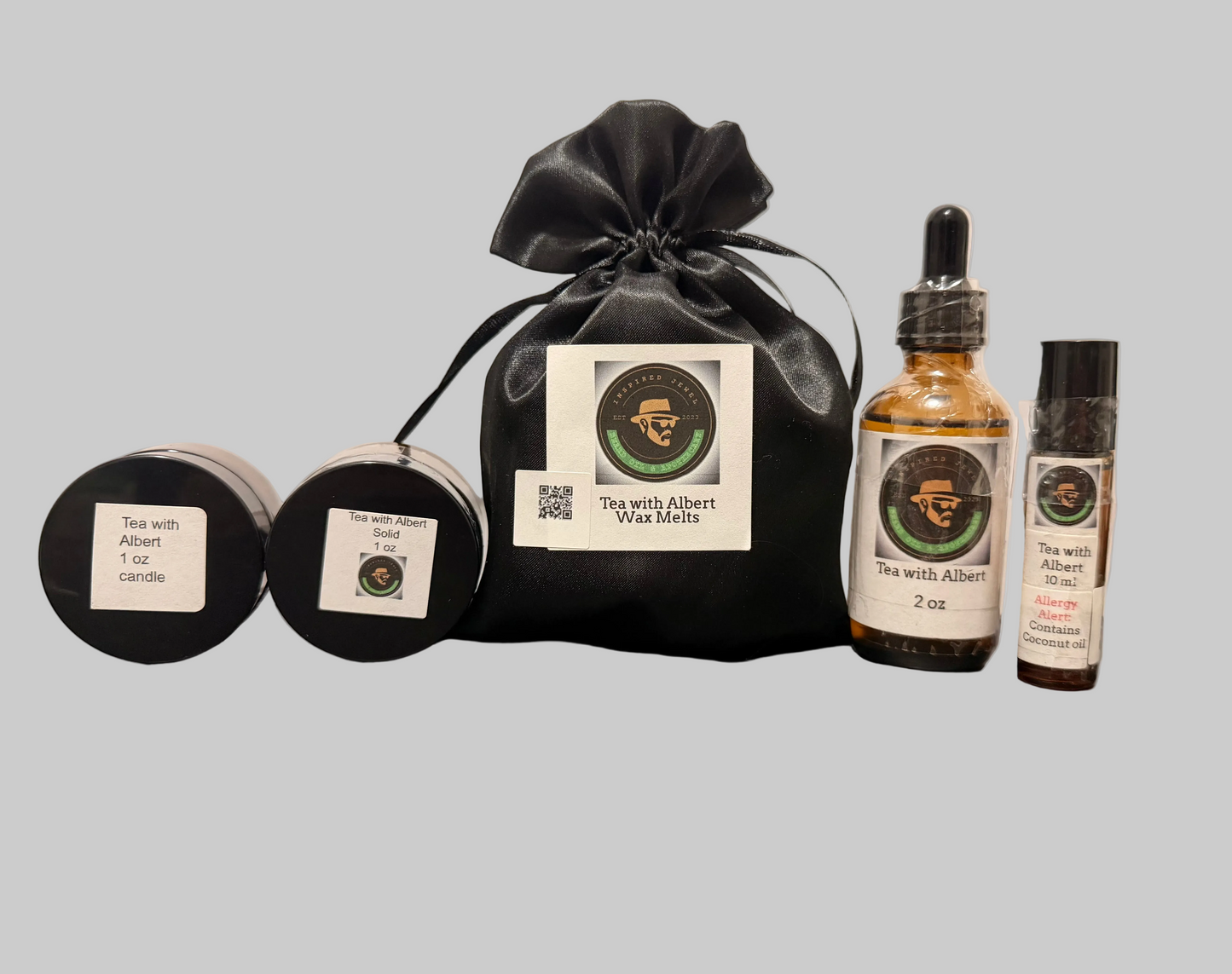 Tea wax melts and botanical essential oils including candles and a bag on a gray background