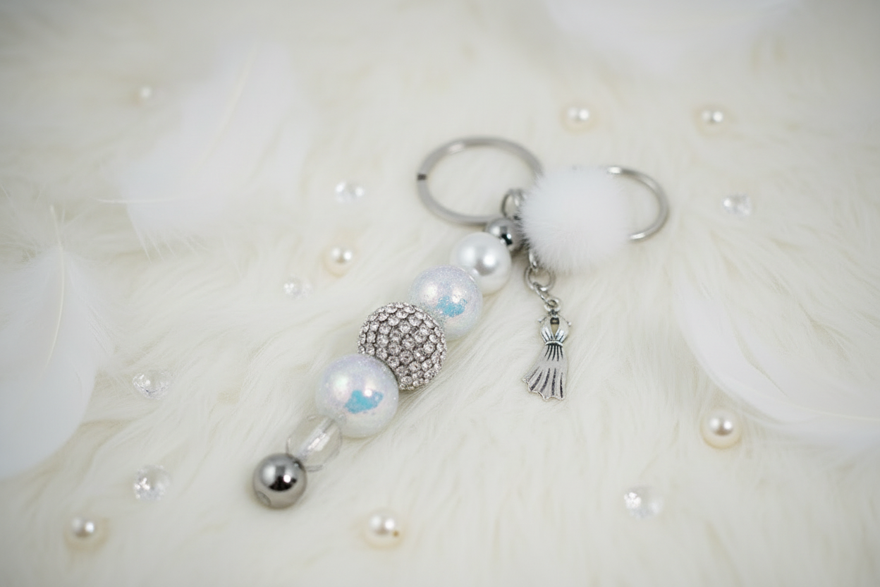 Keychain with pearls and rhinestones with decorative elements on a white fur background