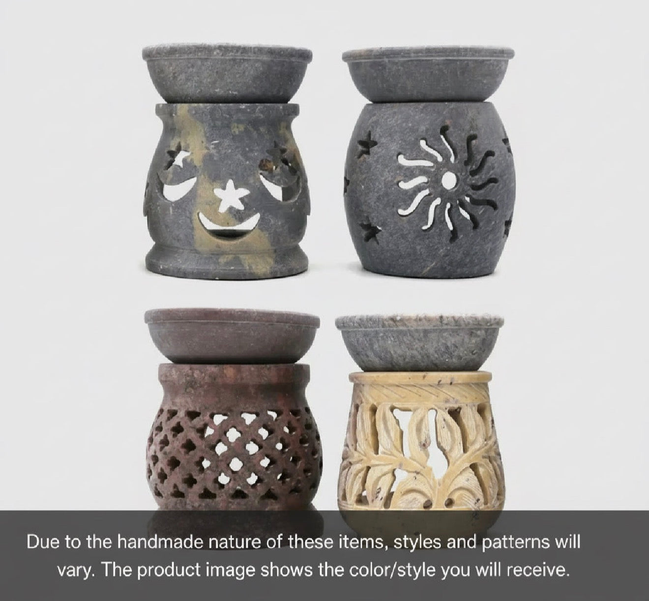 Set of four soapstone oil burners on a light gray background