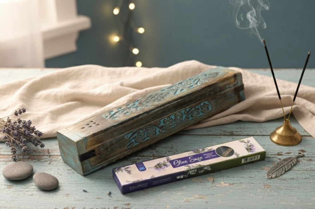 Blue Incense coffin box, incense sticks, and lavender on a wooden surface with a soft focus background.