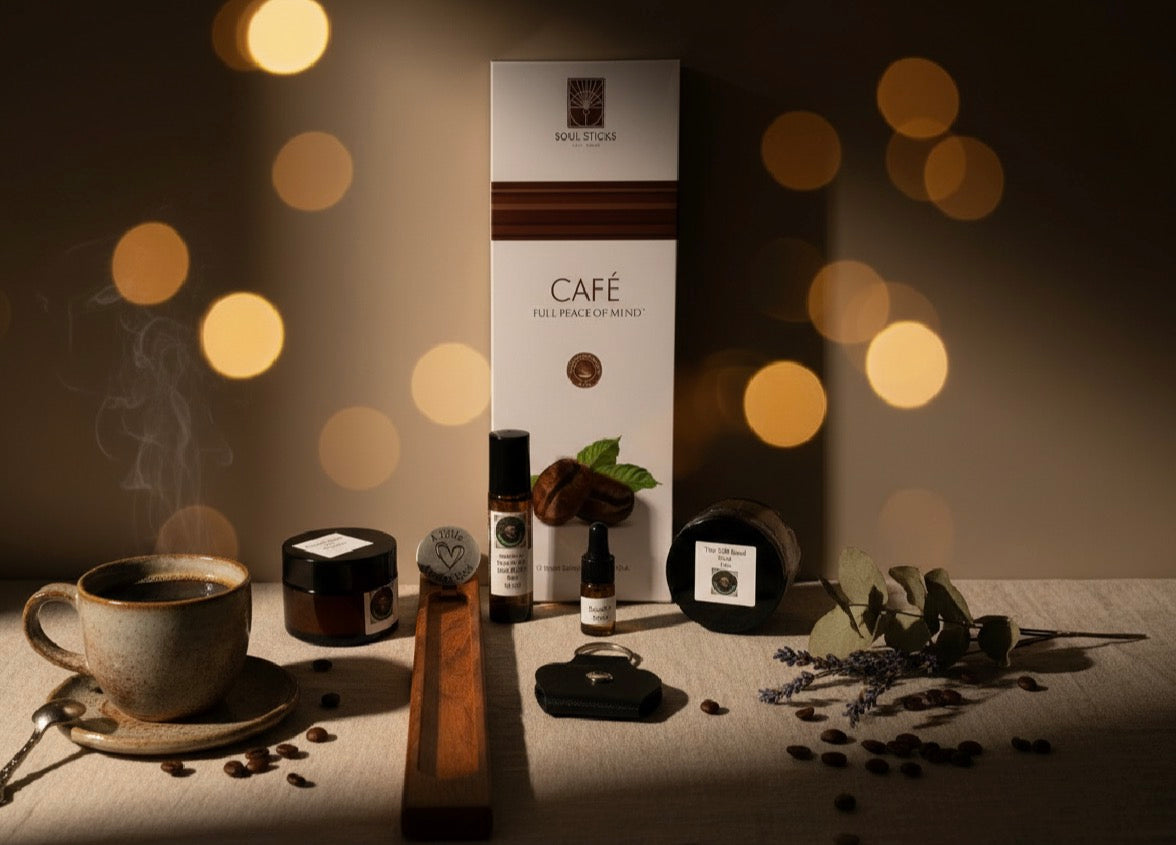 Café incense and burner set with coffee cup, beans, and fragrance items and keepsake item on a table with warm lighting.