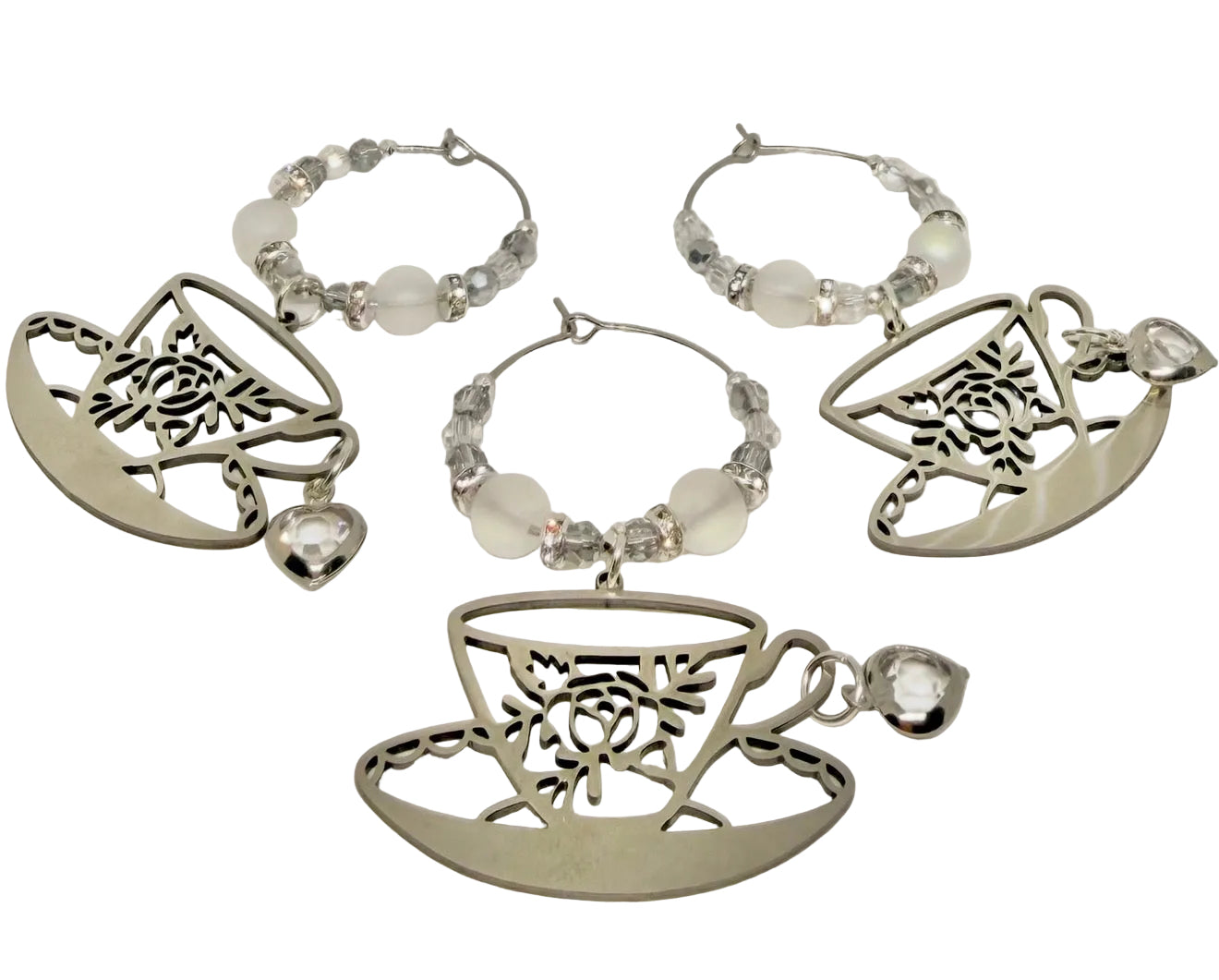 Set of silver tumbler charms with tea cup and teapot designs on a white background