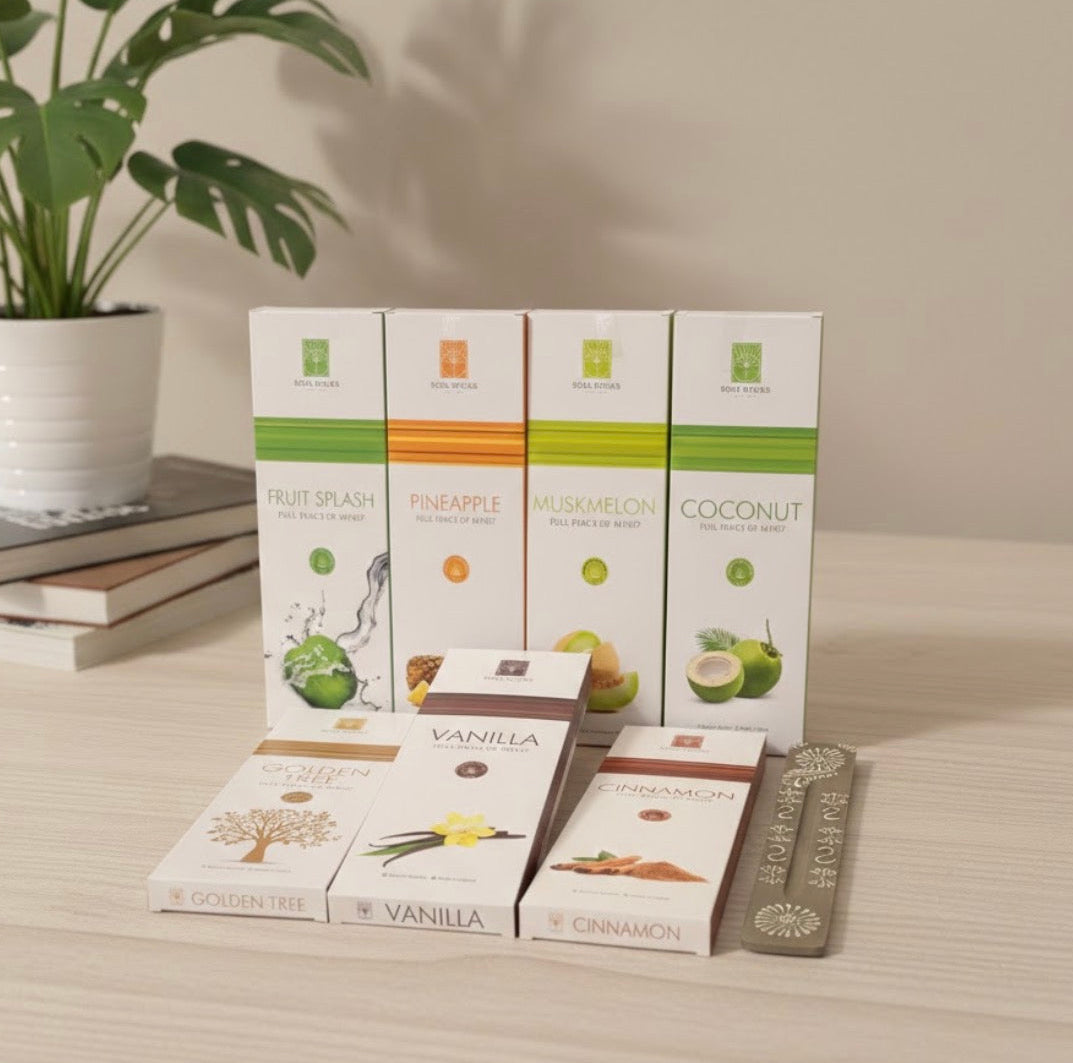 Assorted incense packaging on a wooden surface with a plant in the background