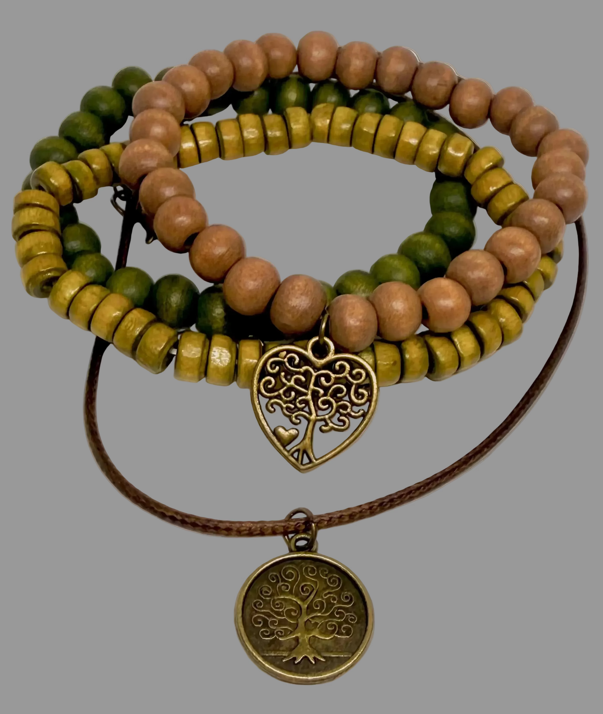 Stack of beaded bracelets with tree-themed pendants on a gray background