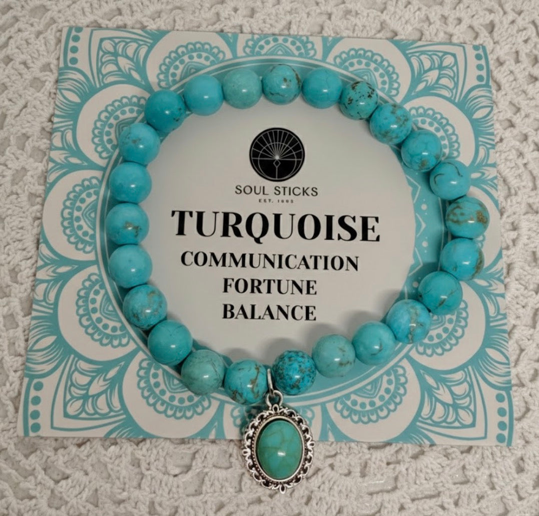 Turquoise beaded bracelet with a pendant on a decorative card with text