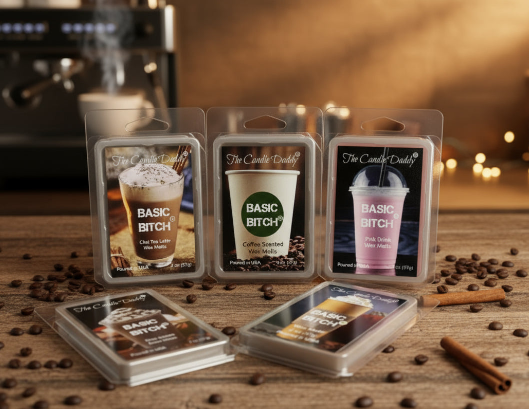 Basic Bitch Wax melts with coffee-themed packaging on a wooden surface with coffee beans and a blurred coffee machine in the background. basic bitch.