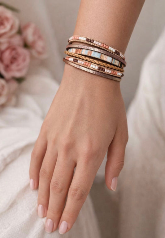 Hand wearing boho wrap bracelet with a soft background