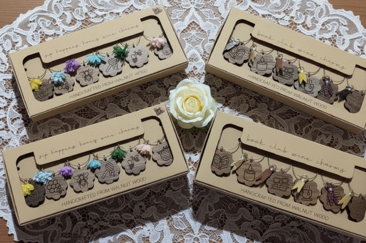 Set of wooden wine stem charms in cardboard packaging on a lace background