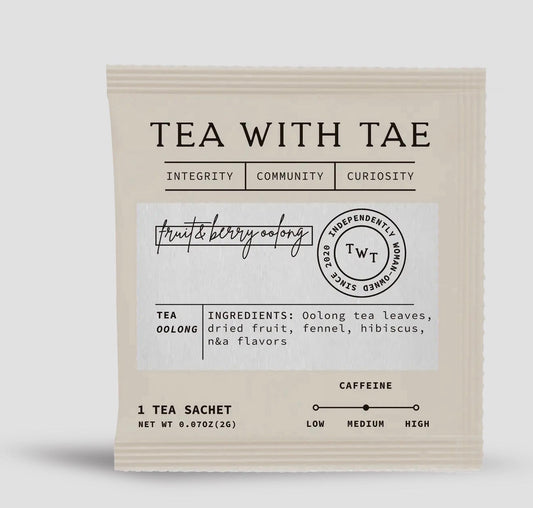 Tea sachet with 'Tea with Tae' branding on a light gray background