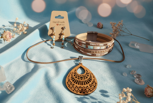 Jewelry set with necklaces and bracelets on a blue fabric background